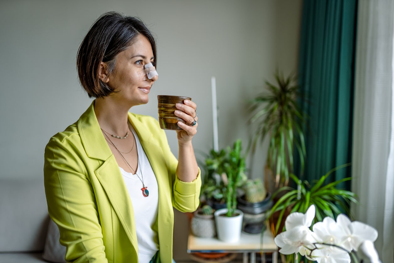 Smiling woman with a broken nose.  