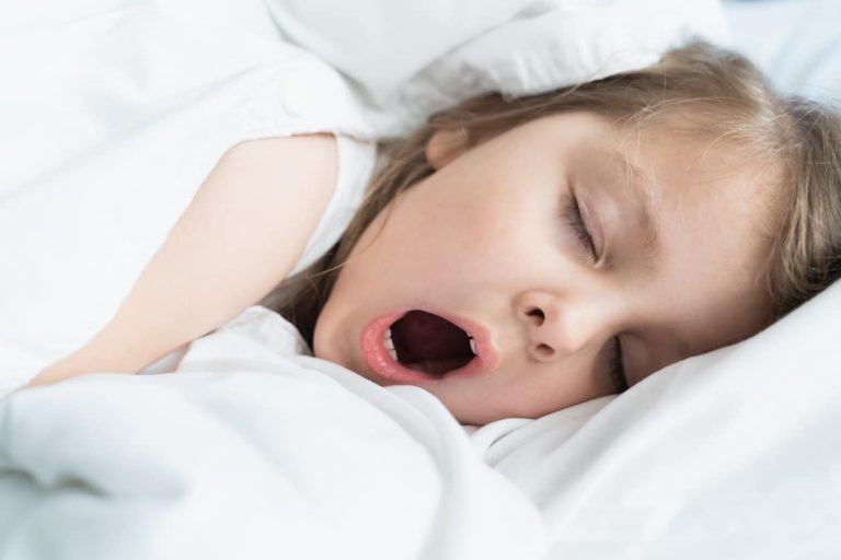 Young girl snoring in bed