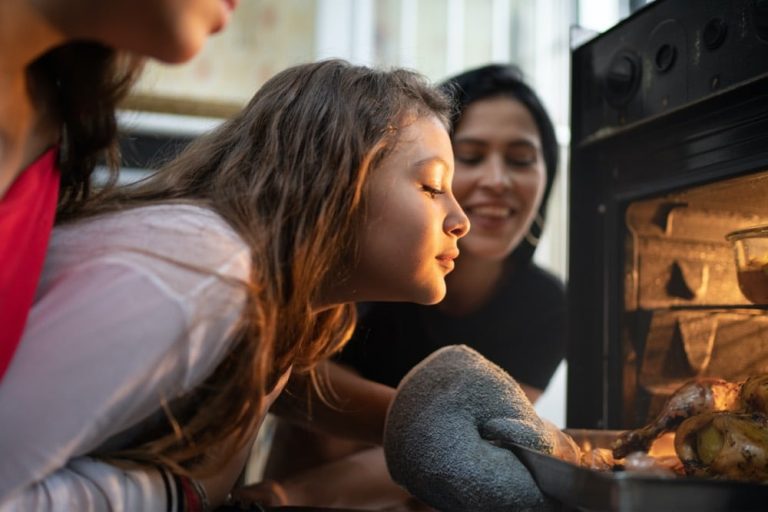 child looking at baking cookies