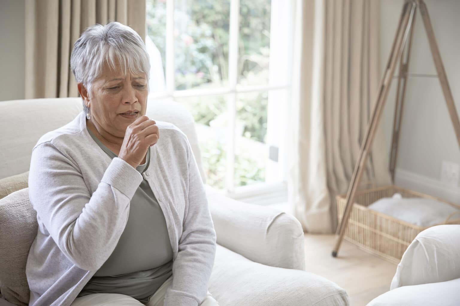 coughing woman in living room 