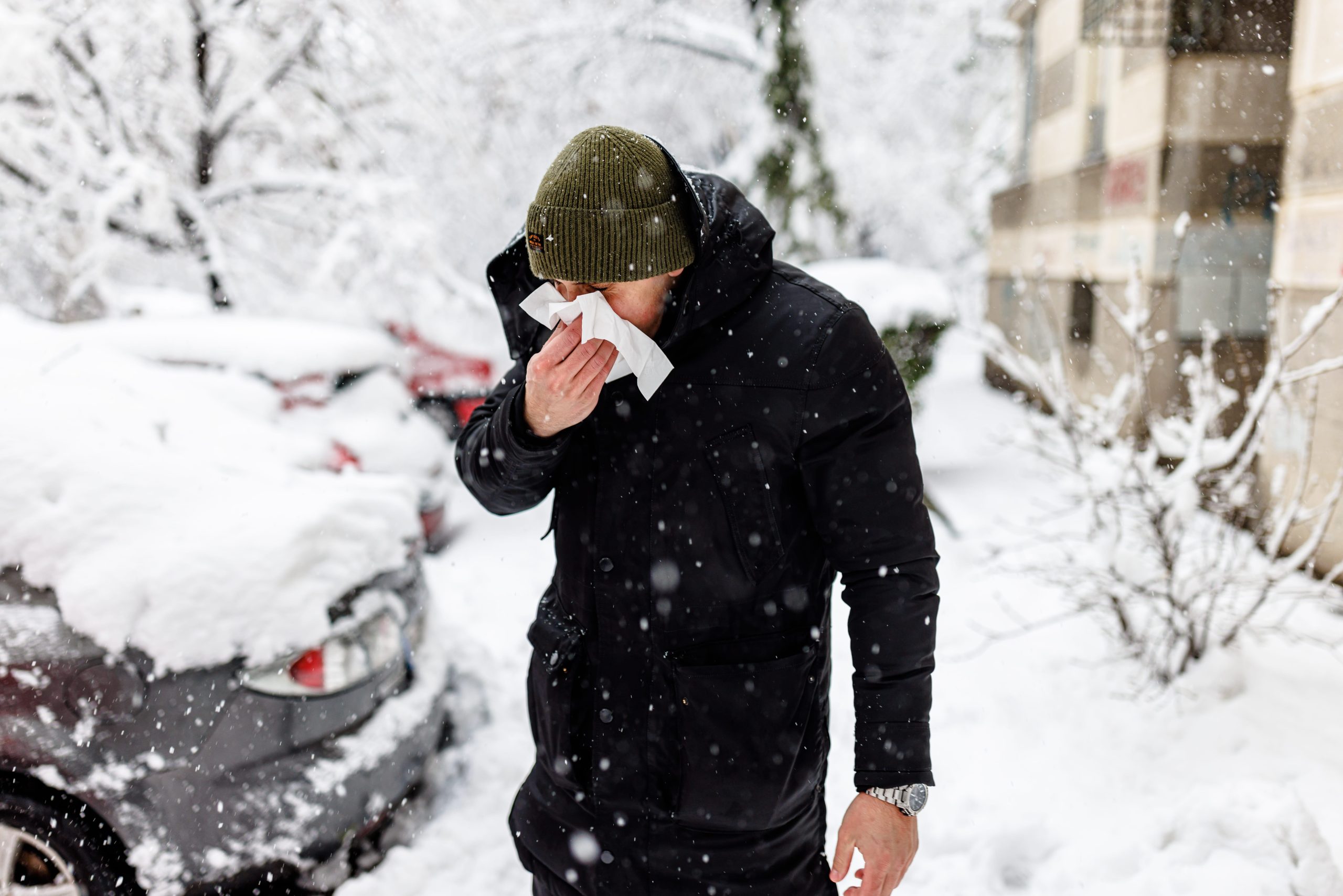 man blowing his nose