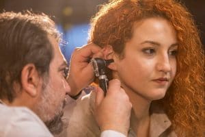 Audiologist looking into a patient's ear